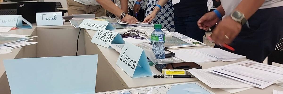 Participants of the UNDAC Induction Course in Saly, Senegal, engaged in the desk top Exercise, simulating an earthquake response in the fictional country of Epeigonia.