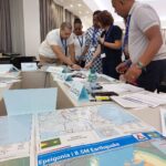 Participants of the UNDAC Induction Course in Saly, Senegal, engaged in the desk top Exercise, simulating an earthquake response in the fictional country of Epeigonia.