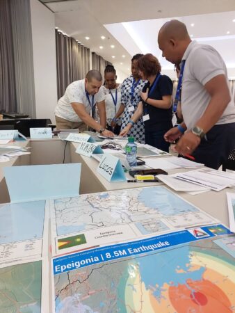 Participants of the UNDAC Induction Course in Saly, Senegal, engaged in the desk top Exercise, simulating an earthquake response in the fictional country of Epeigonia.